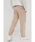 Spodnie męskie New Balance spodnie dresowe bawełniane męskie kolor beżowy z nadrukiem