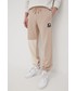 Spodnie męskie New Balance spodnie dresowe bawełniane męskie kolor beżowy z nadrukiem
