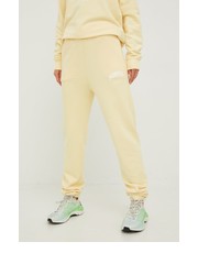 Spodnie spodnie dresowe bawełniane damskie kolor żółty z nadrukiem - Answear.com Guess